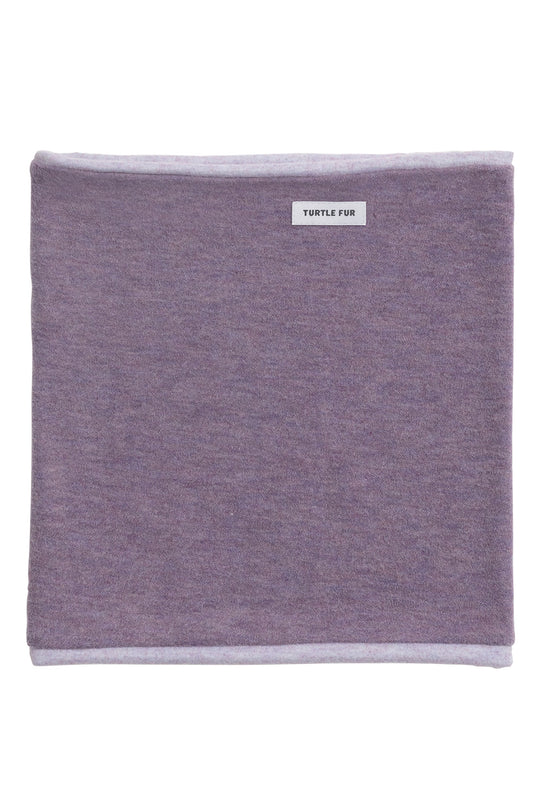 A square heathered lavender-purple neck warmer with light gray stitched borders and a small white brand label reading 'TURTLE FISH' near the top edge, shown on a plain white background.