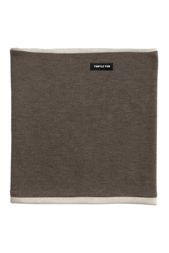 A square brown neck warmer with cream-colored borders on the top and bottom edges, featuring a small black brand label that reads 'TURTLE FUN'.
