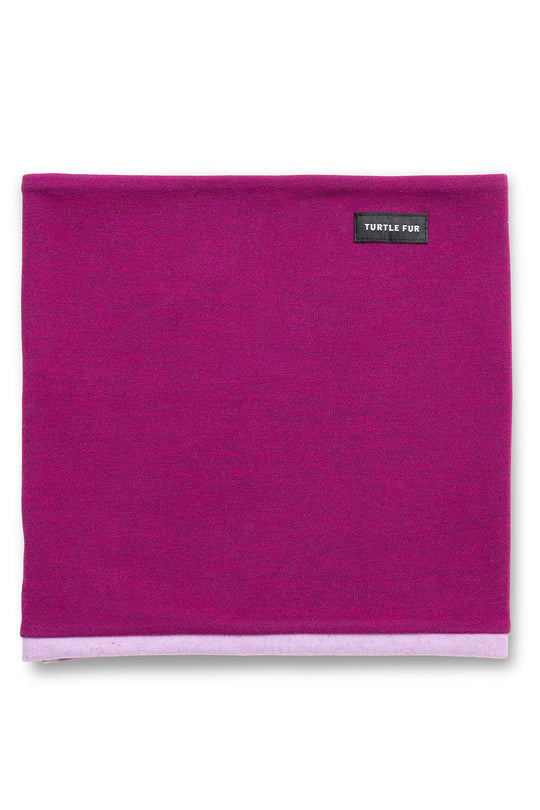 A folded magenta fleece neck warmer with a small black brand label reading 'TURTLE FOR' near the top right, set against a plain white background.