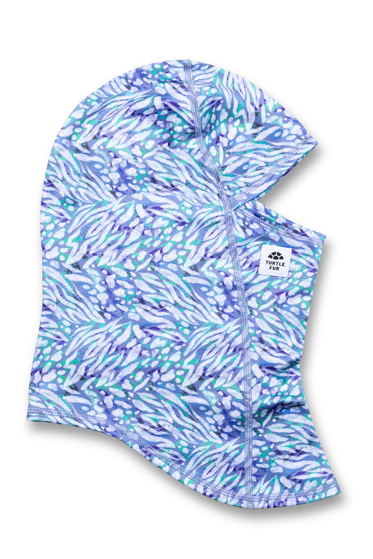 A hooded neck gaiter with an abstract blue, purple, and white pattern, featuring a small white brand label on the side.