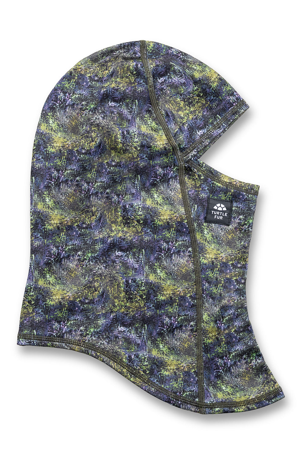 A camouflage balaclava face mask with a hood, featuring a pattern of green, yellow, and dark blue-gray. It has a small black brand patch on the side with the text 'Klimt Peak'.