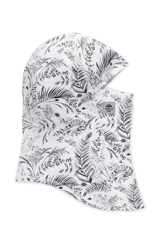 A white balaclava face mask with a black botanical leaf pattern, featuring a small gray brand label on the side.