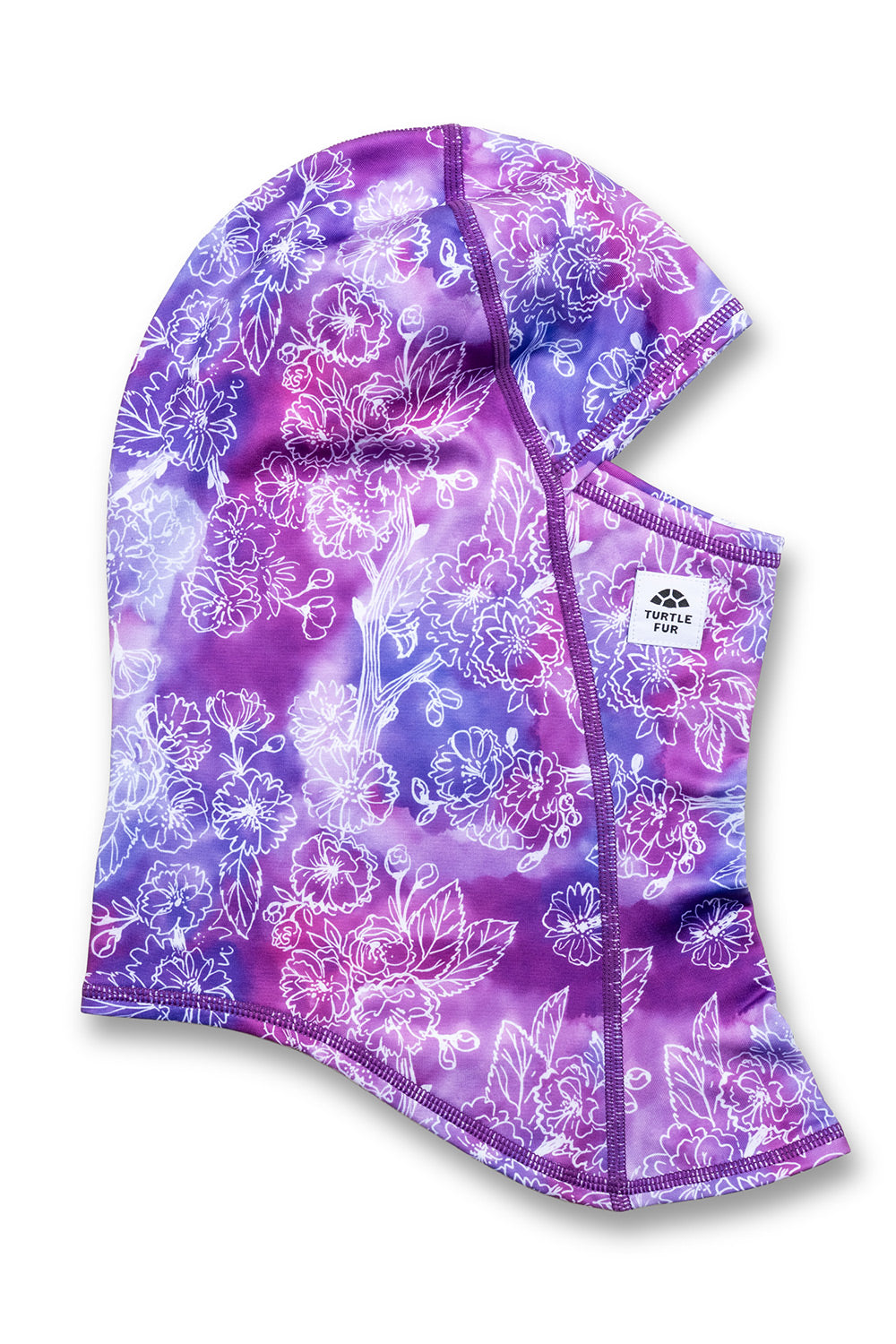 A purple and blue floral hooded face mask with a white floral pattern, featuring a small white brand label on the side.