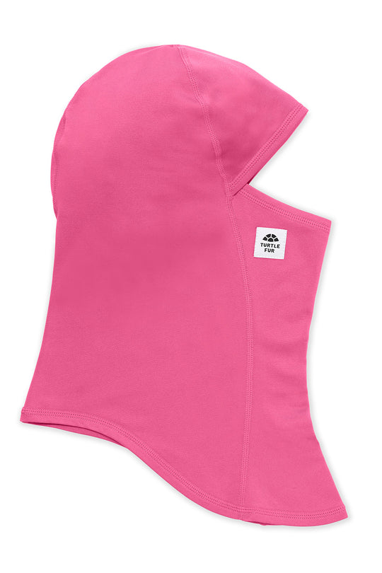 A bright pink balaclava face covering with an integrated hood and neck flap, featuring a small white brand label on the side, shown against a plain white background.