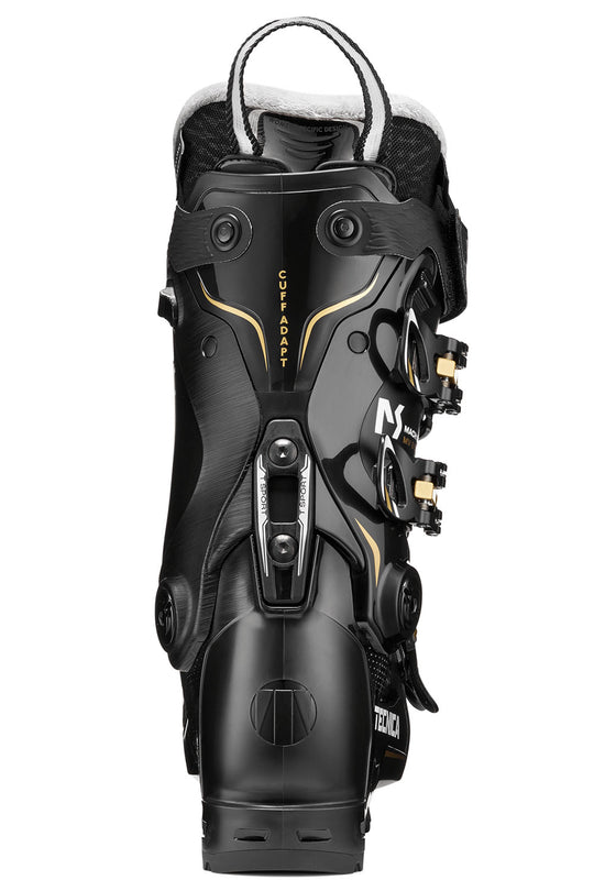 Black ski boot with gold accents on a white background