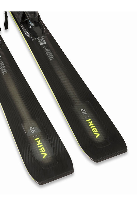 Black ski boots with yellow branding on a white background