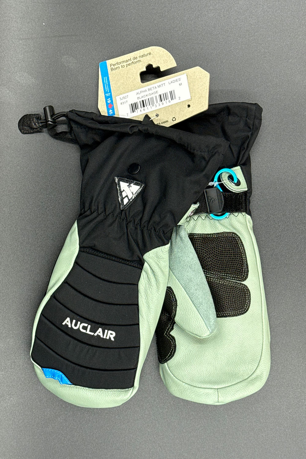 Pair of black and light green mittens with 'Auclair' branding on a gray background