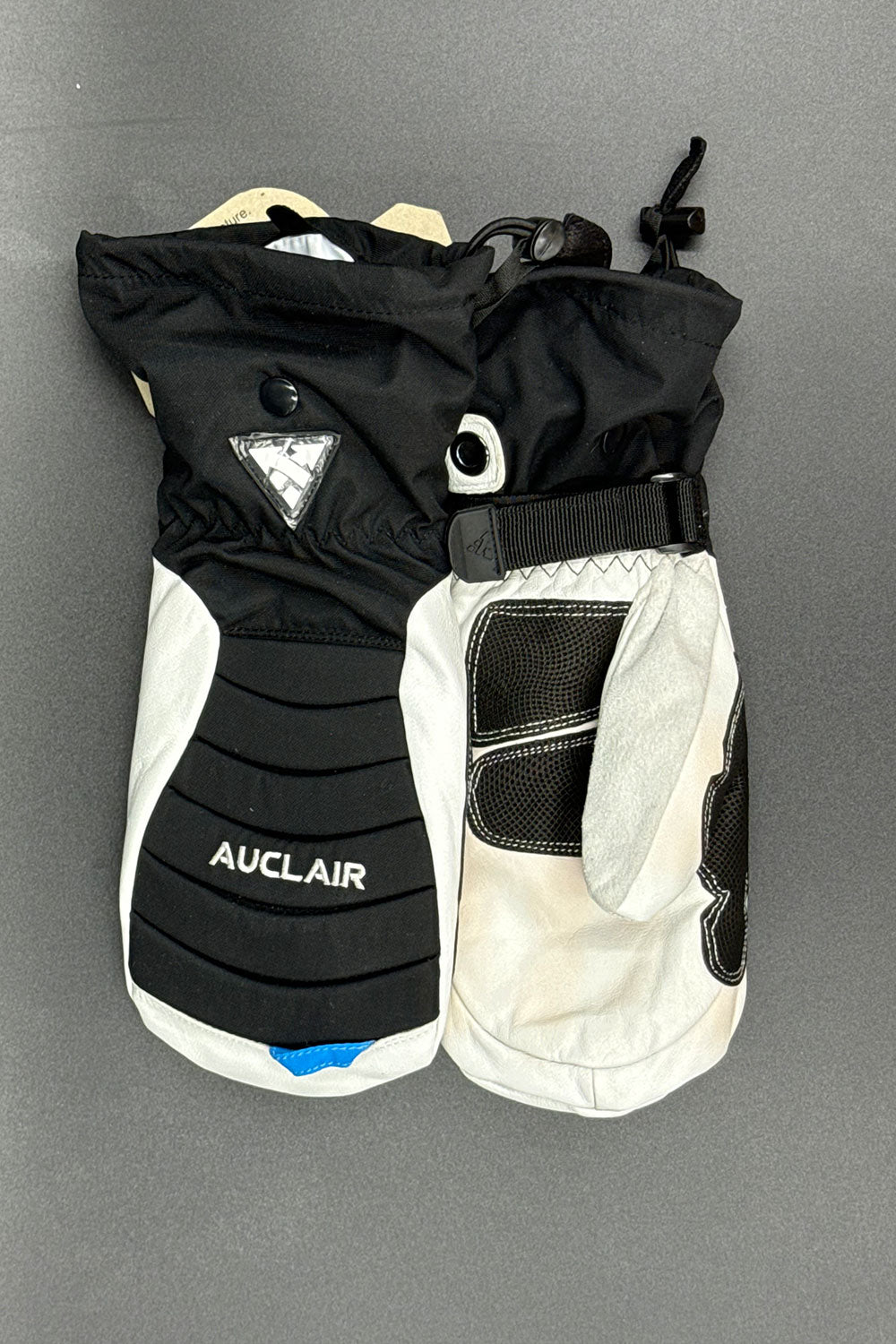 Black and white ski glove with 'Auclair' branding on a gray background