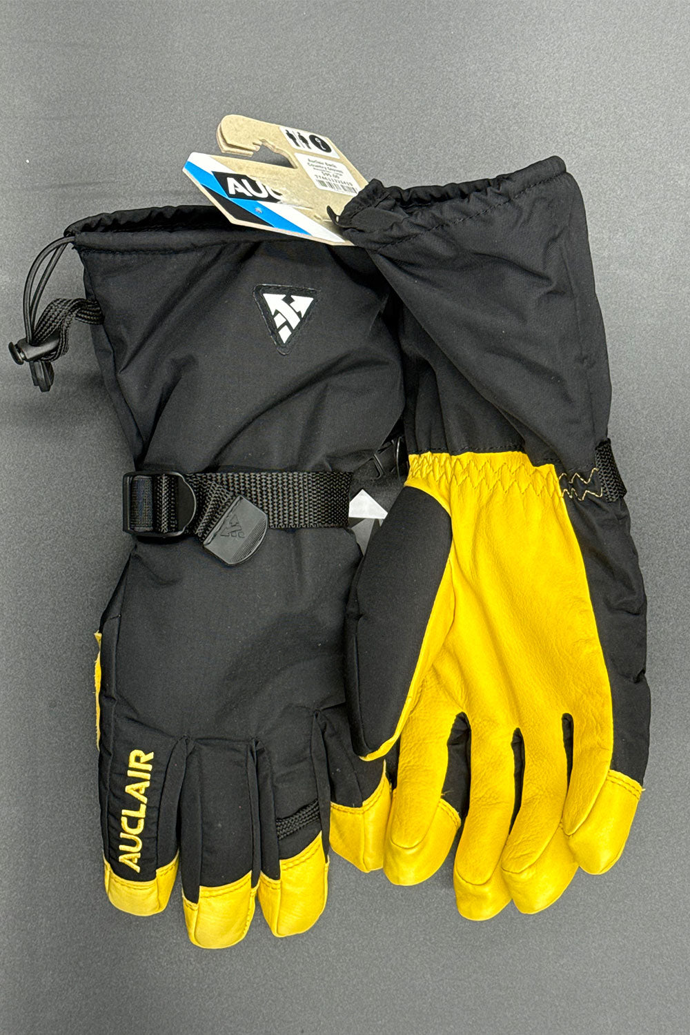 Black and yellow gloves with a visible brand logo on a gray background