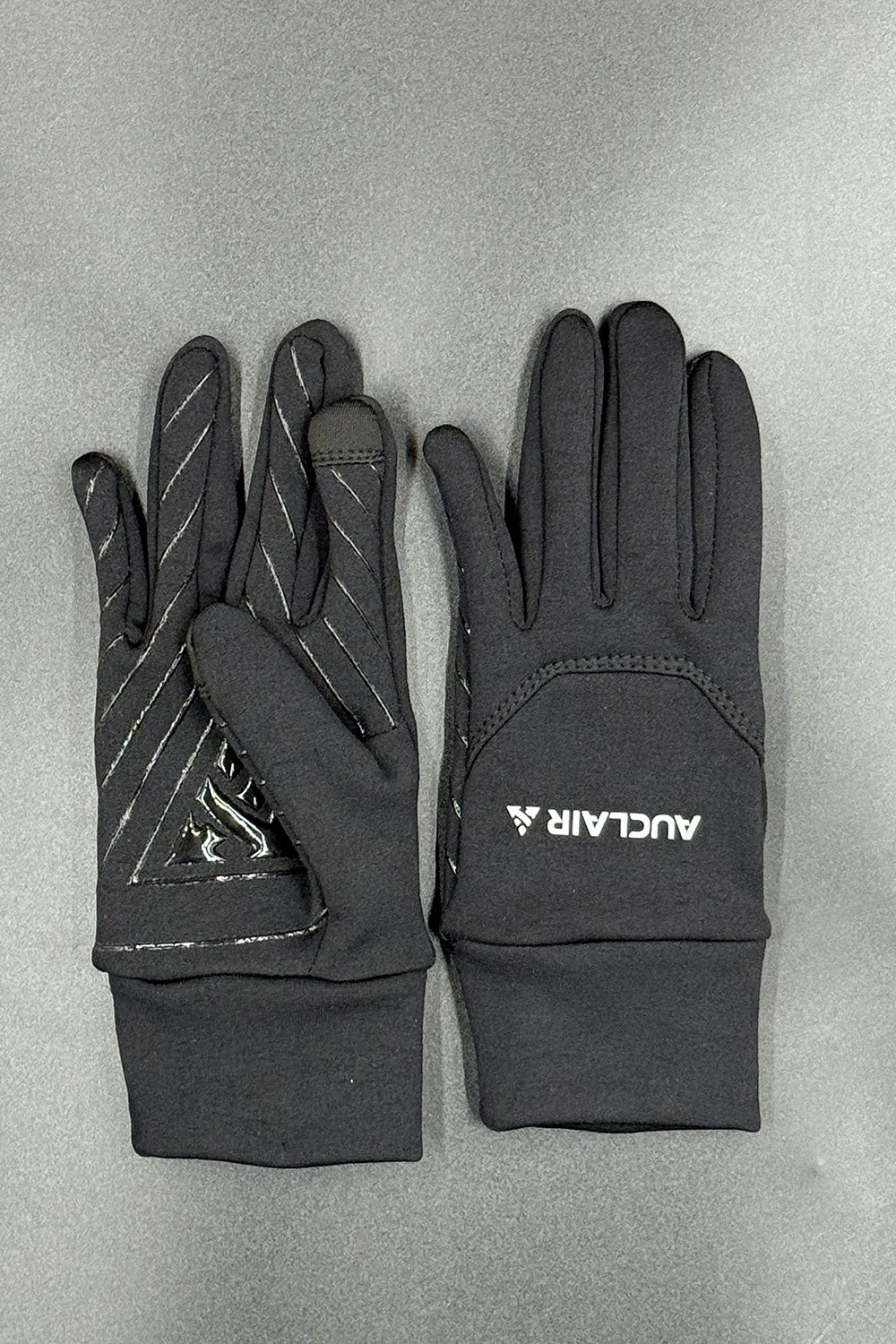 Black gloves with a brand logo on a gray background