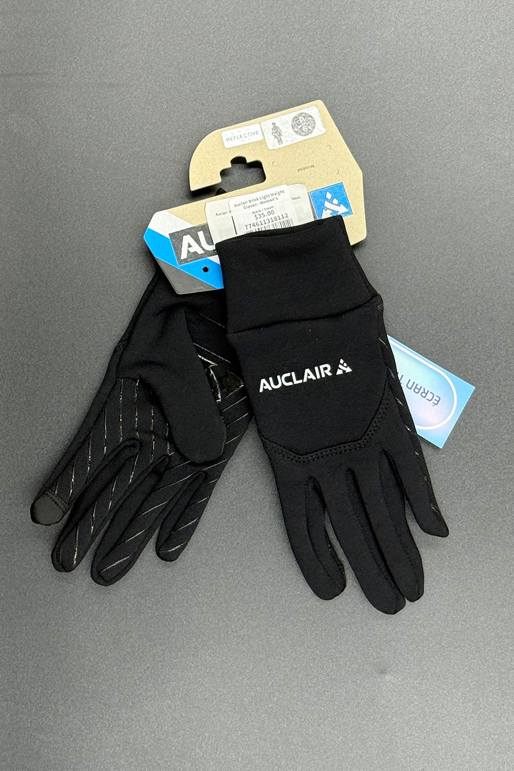 Black gloves with 'Auclair' branding on a gray background