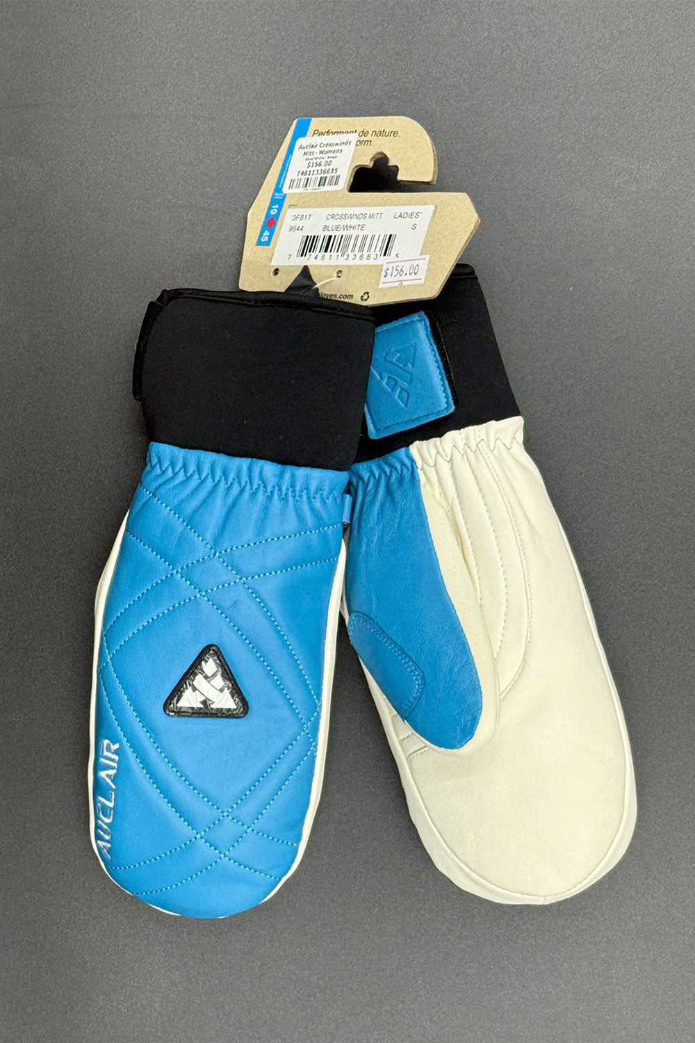 Pair of blue and white gloves with a brand logo on a gray background