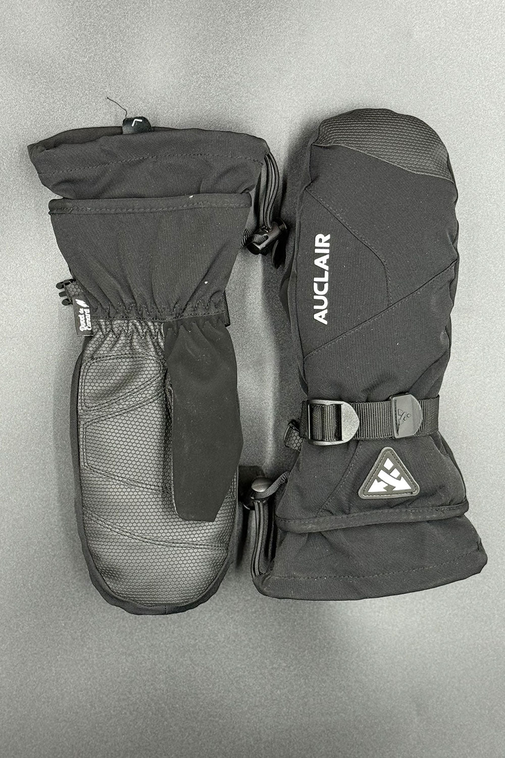 Pair of black Auclair mittens on a gray background