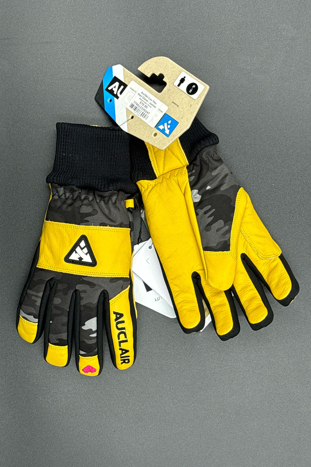 Pair of black and yellow gloves with a brand tag on a gray background