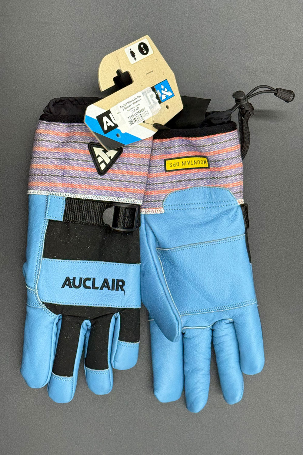 Pair of blue gloves with 'Auclair' branding on a gray background