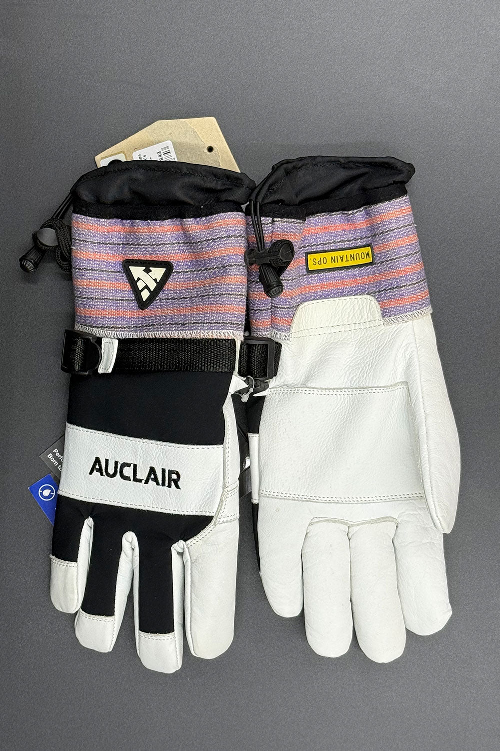 Pair of gloves with 'Auclair' branding on a gray background