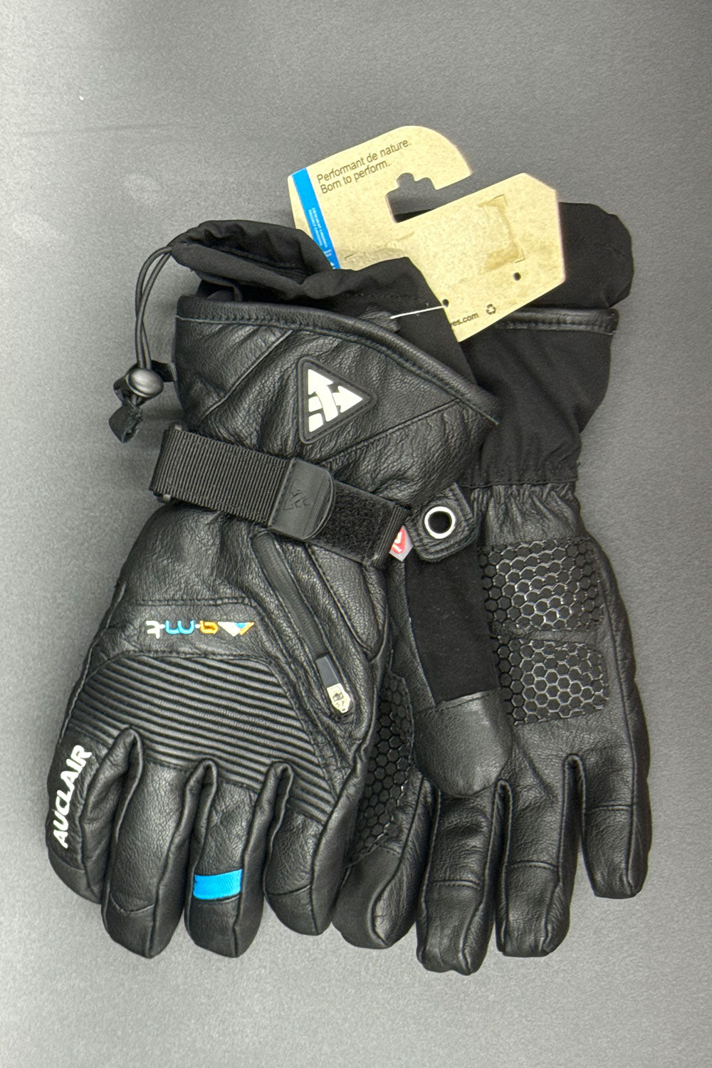 Pair of black gloves with brand logo on a gray background