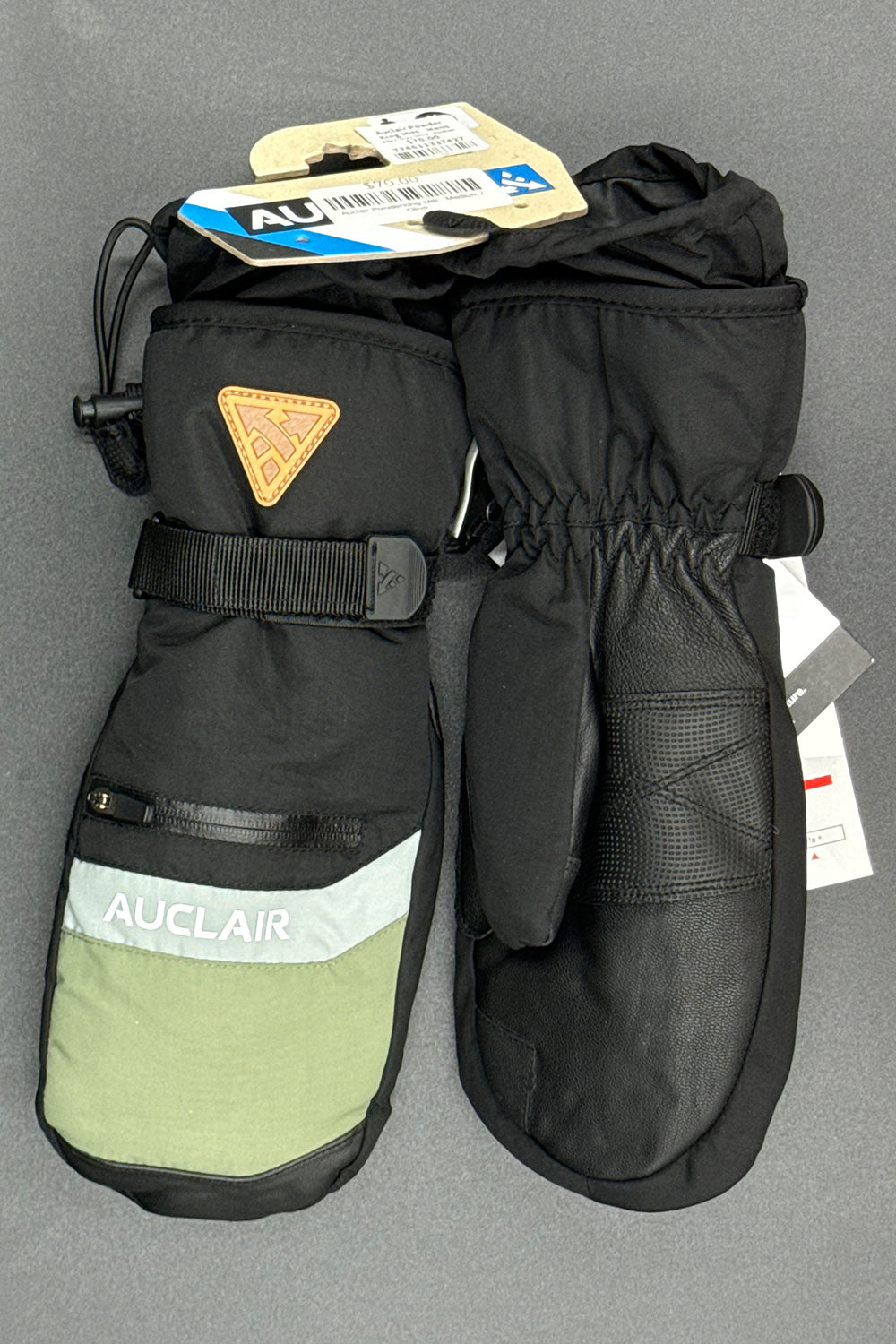 Pair of black and green mittens with Auclair branding on a gray background
