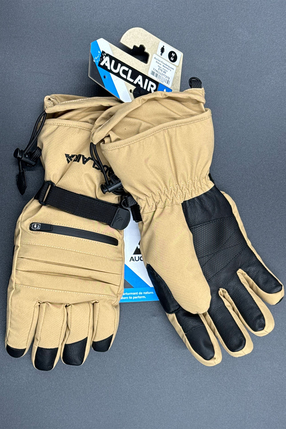 Pair of beige gloves with black accents on a gray background, featuring the brand 'Auclair'.