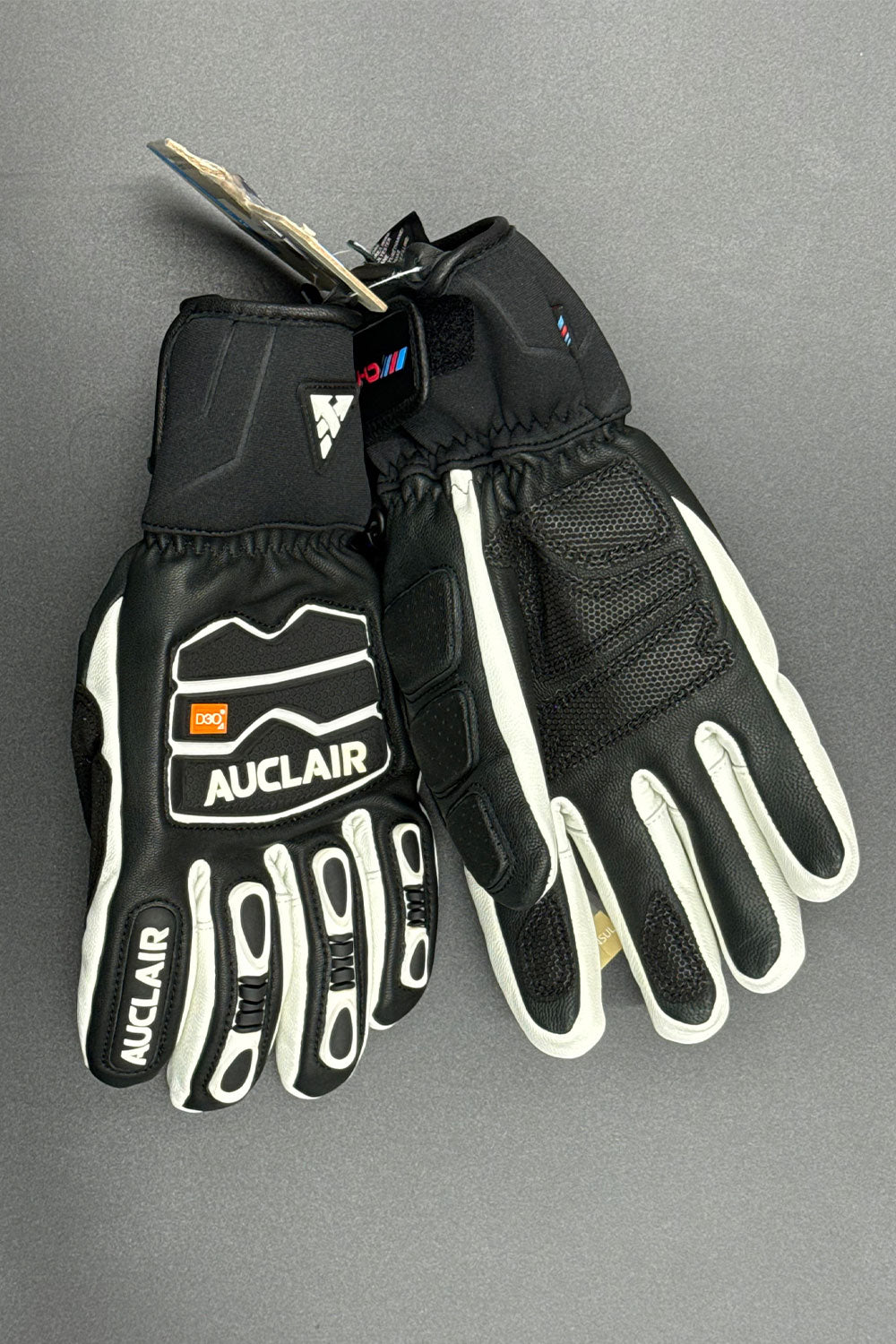 Black and white gloves with 'Auclair' branding on a gray background
