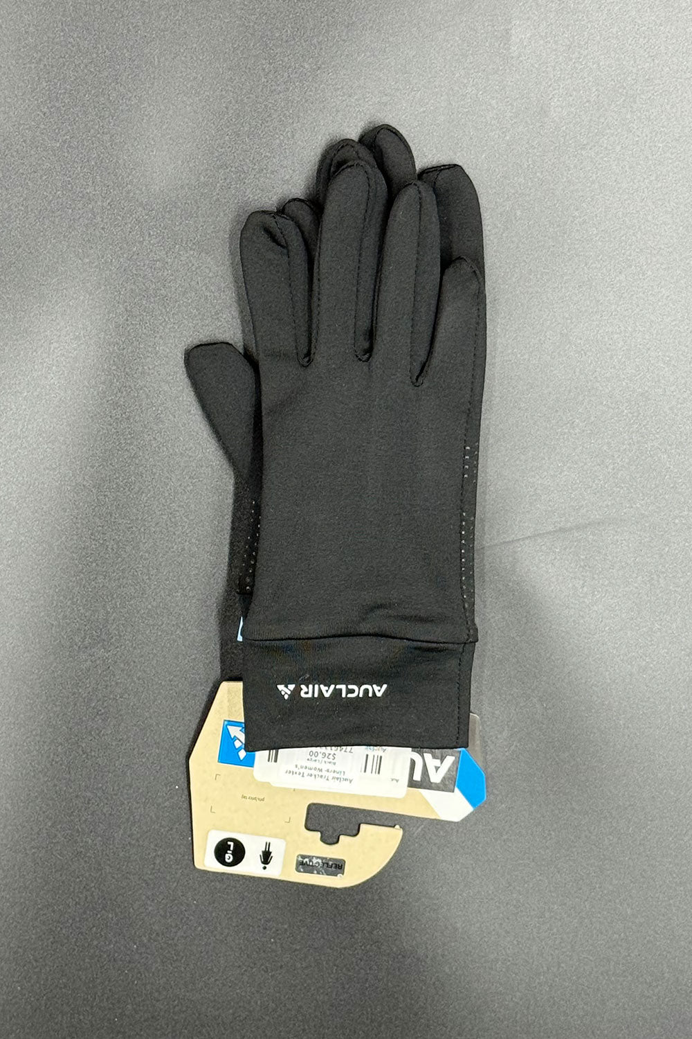 Black gloves on a gray background with a visible brand label.