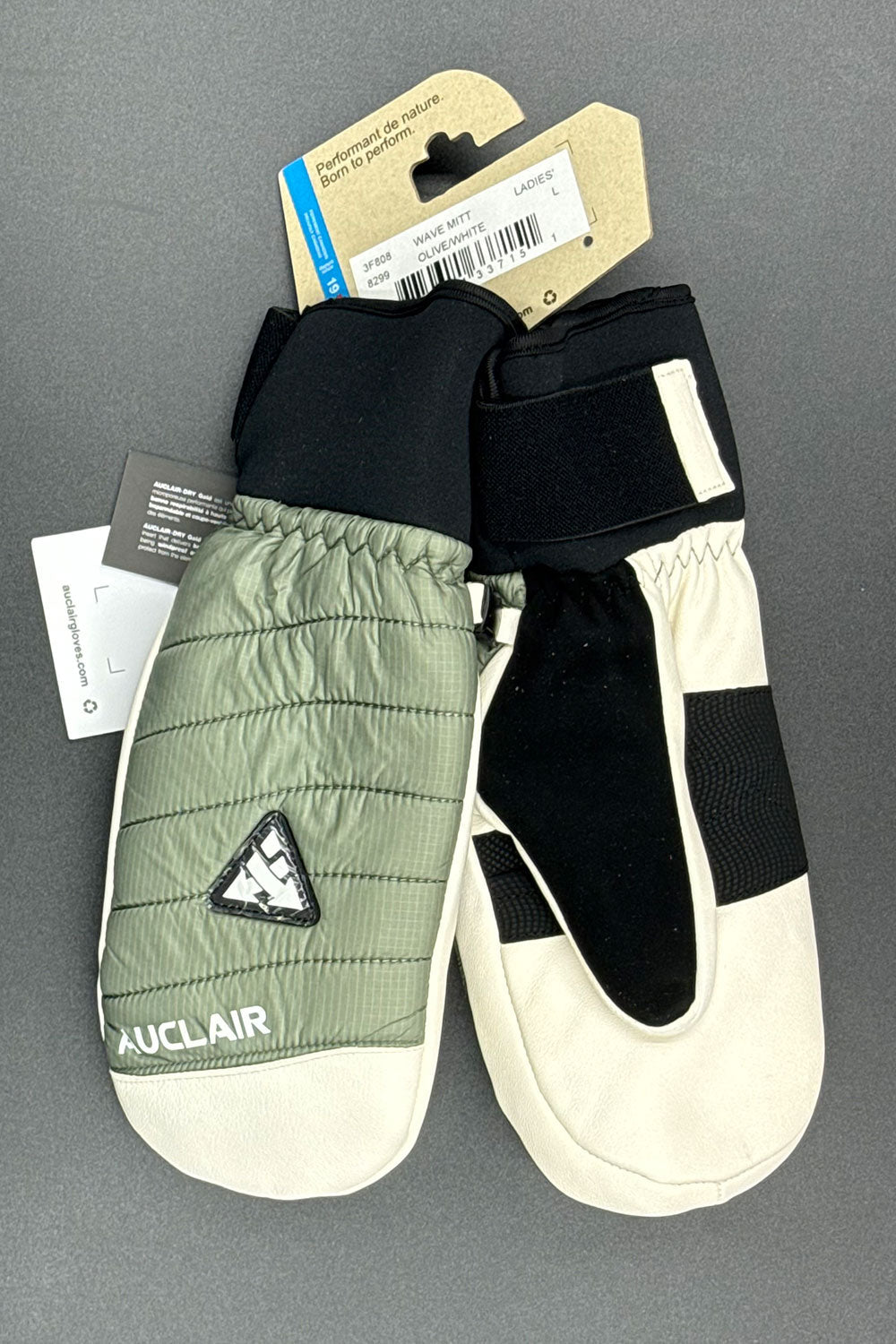 Pair of green and black gloves with a brand label on a gray background