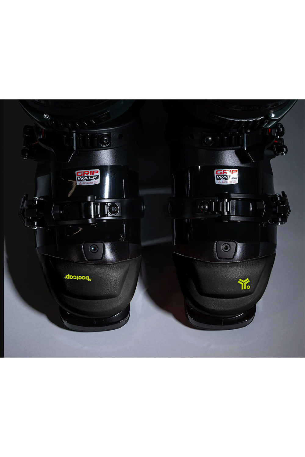 Black ski boots with visible branding on a dark background