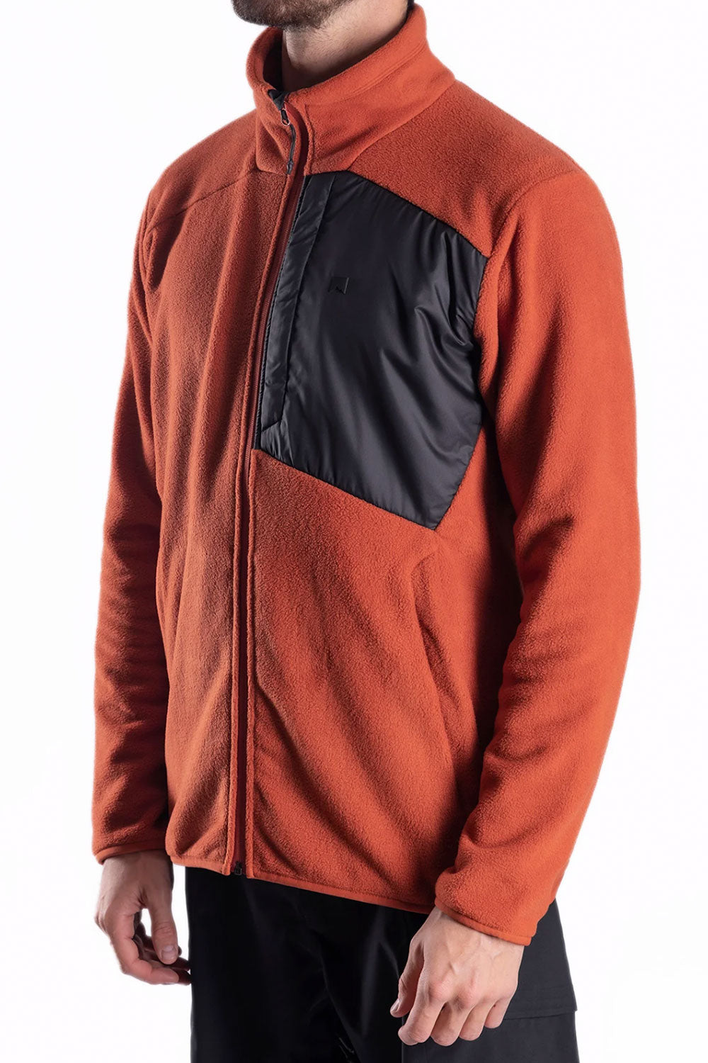 Orange fleece jacket with black patch on a white background
