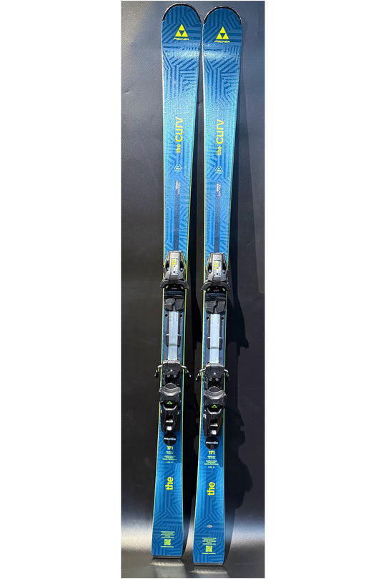Pair of blue skis with bindings on a dark background