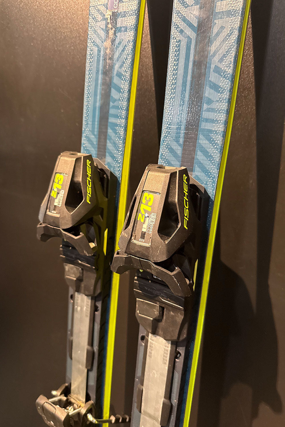 Pair of skis with bindings on a dark background