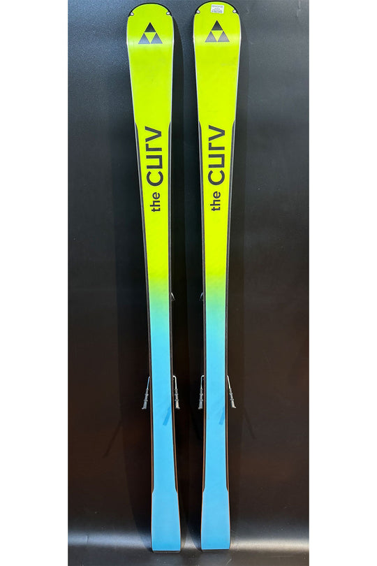 Two skis with a gradient color from green to blue on a dark background