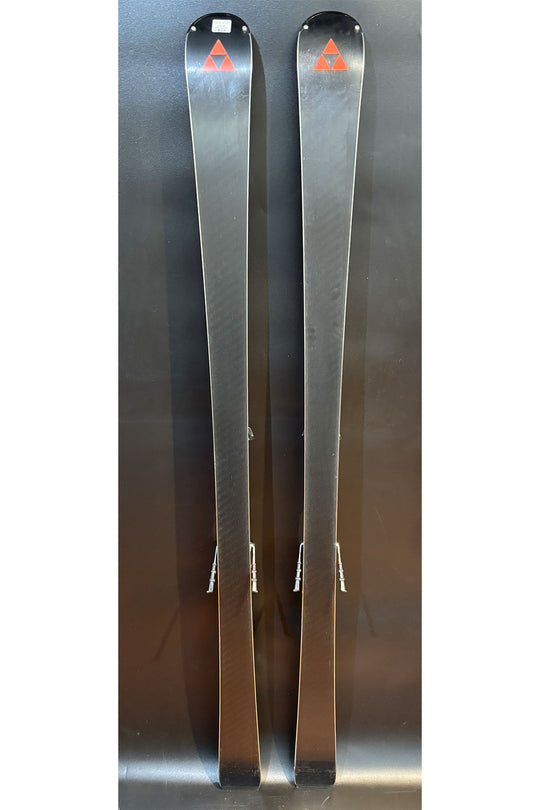 Two silver skis with a logo on a reflective surface