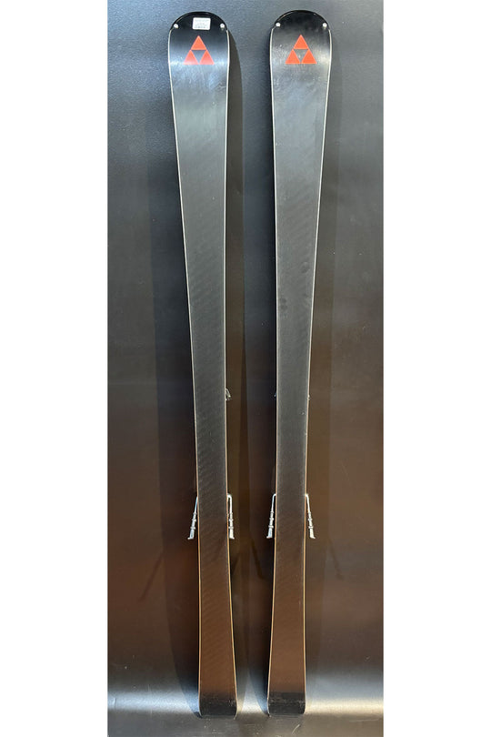 Two silver skis with a logo on a reflective surface