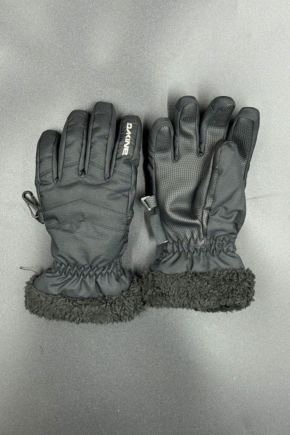 Pair of black gloves with fur lining on a gray background