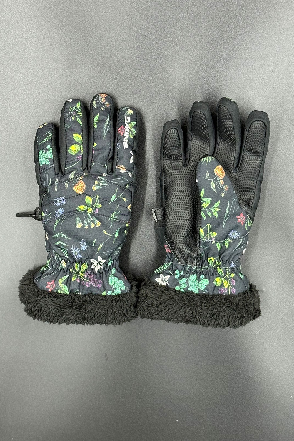 Pair of floral-patterned gloves with black cuffs on a gray background