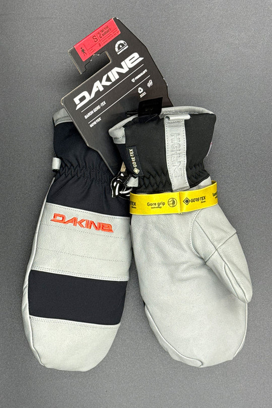 Pair of gray and black gloves with Dakine branding on a gray background