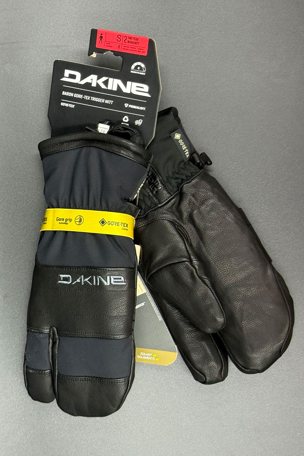 Pair of black gloves with Dakine branding on a gray background