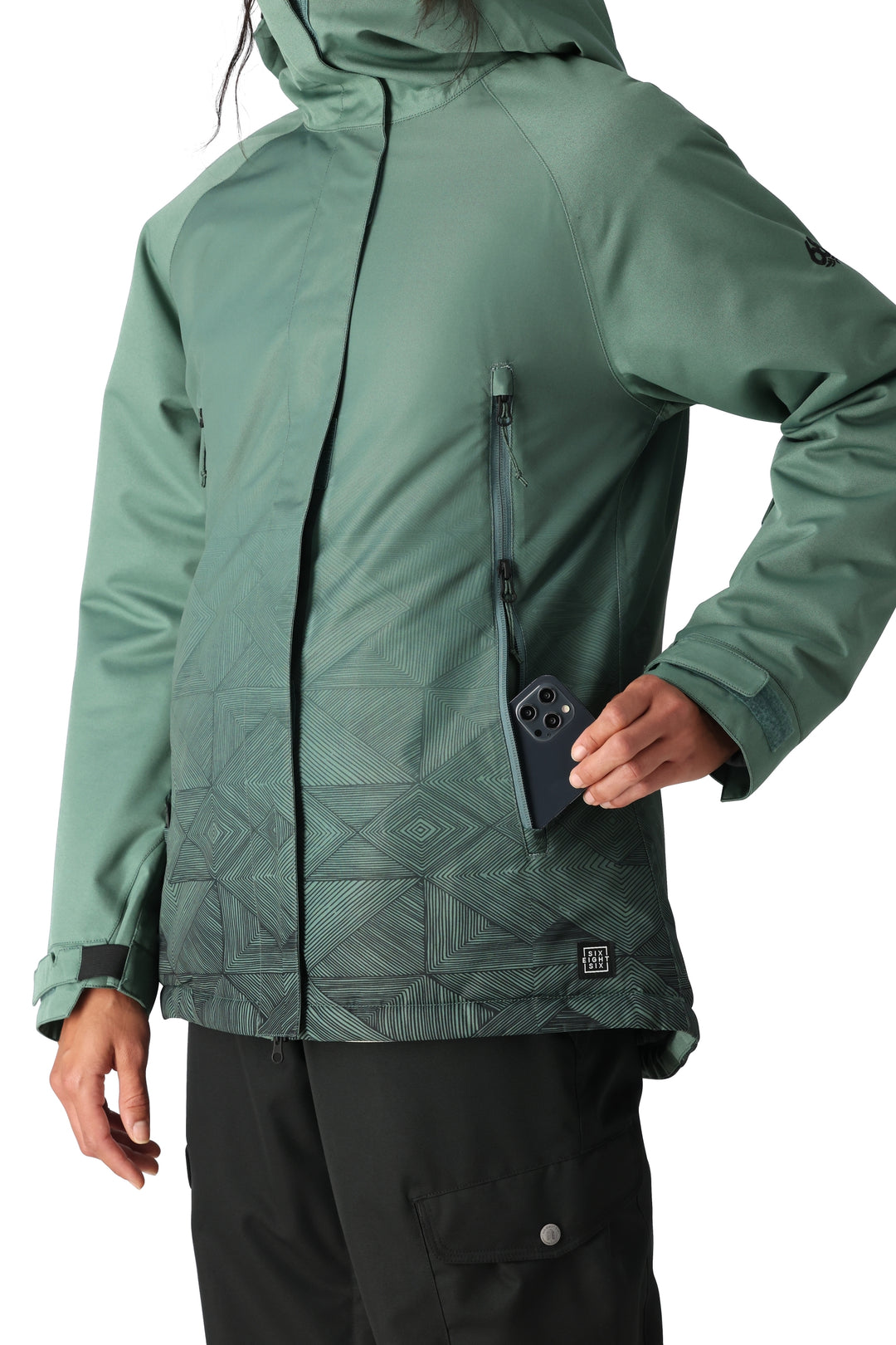 Women's 686 Fantasia snowboard jacket, Cypress green with black geometric pattern on bottom