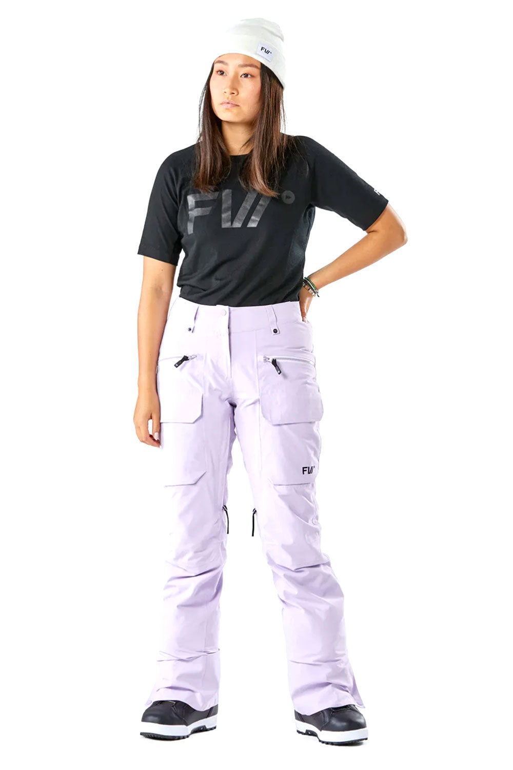 Person wearing a black t-shirt and  light purple ski pants with visible branding on a white background