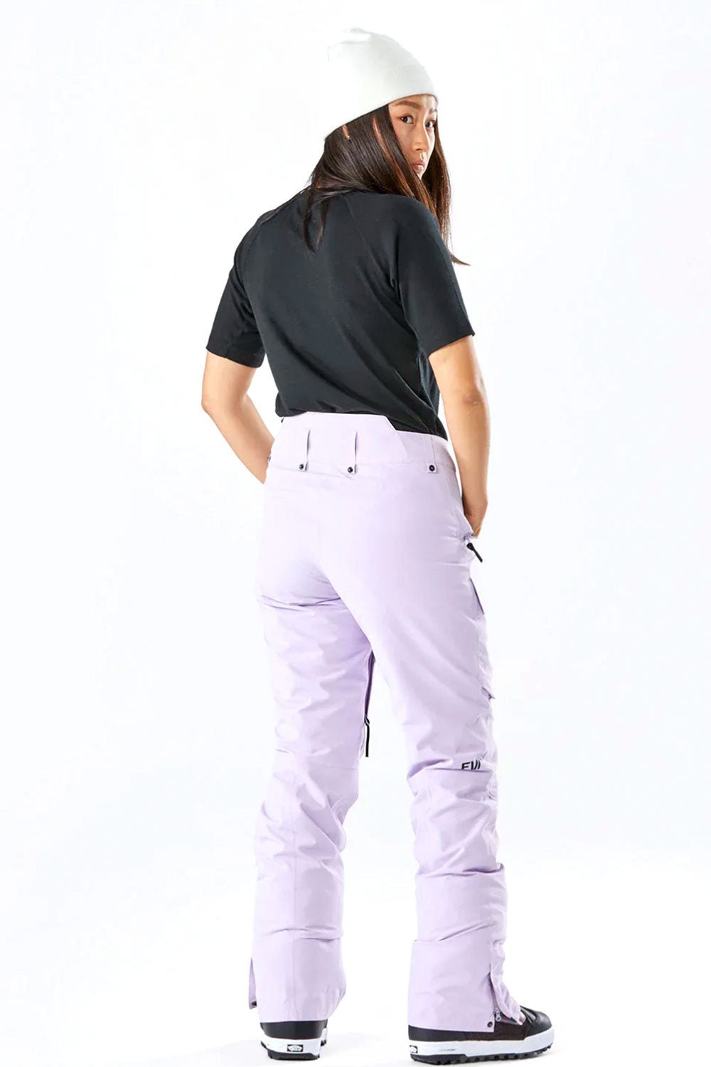 Person wearing a black shirt and light purple pants on a white background