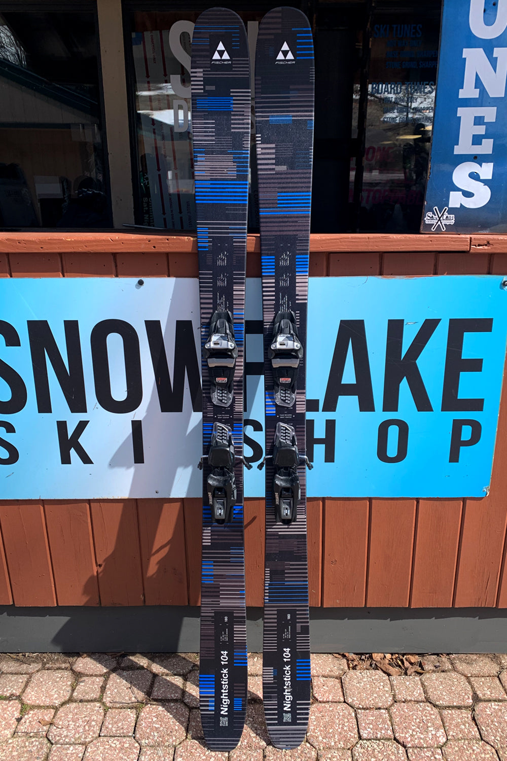 Fischer Nightstick 104 demo skis,  blue, gray and black line pattern with black demo bindings