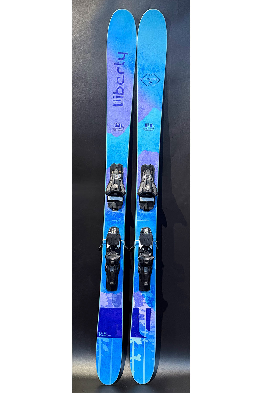 Blue skis with bindings on a black background