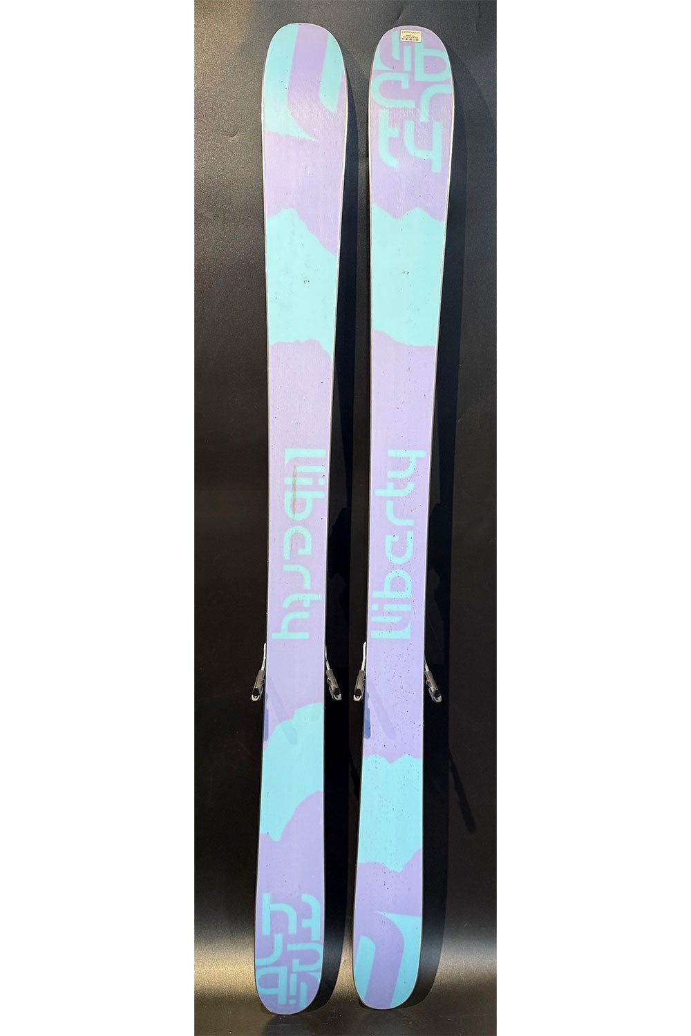Pair of skis with a colorful design on a black background