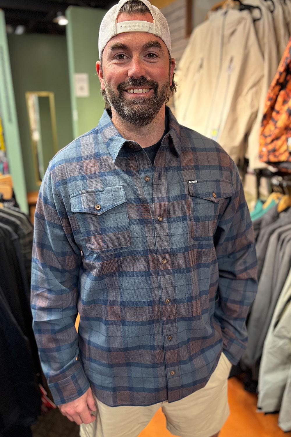 person wearing a flannel shirt in a store setting