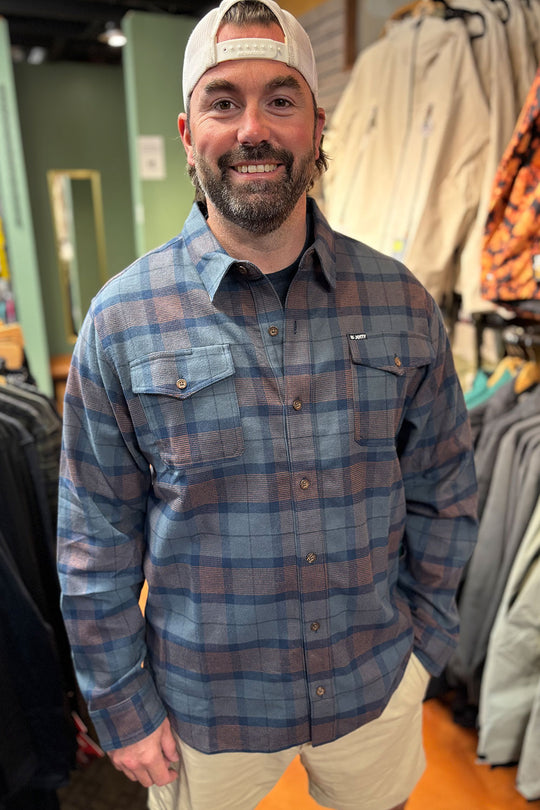 person wearing a flannel shirt in a store setting
