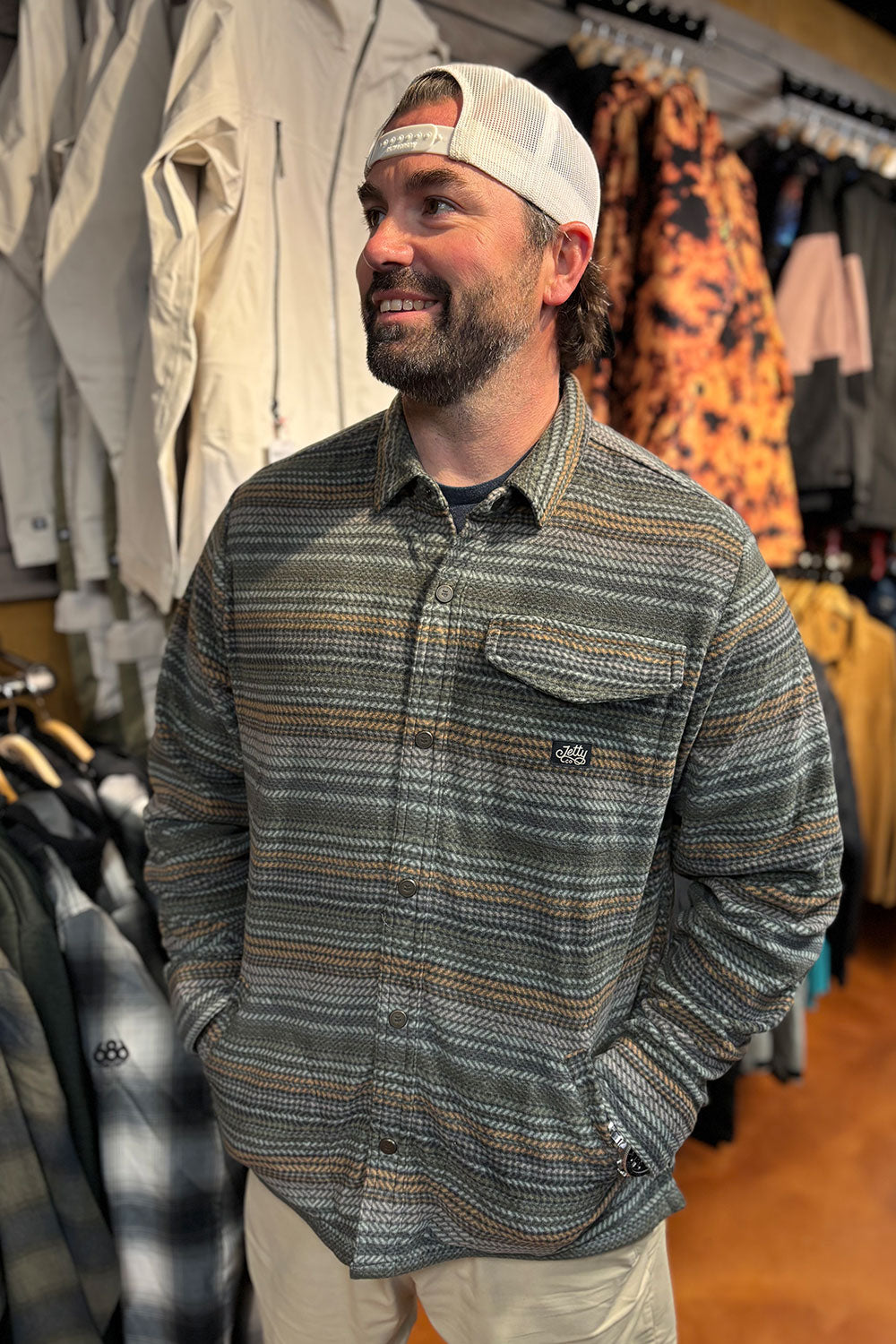person wearing a fleece shirt jacket in a store setting
