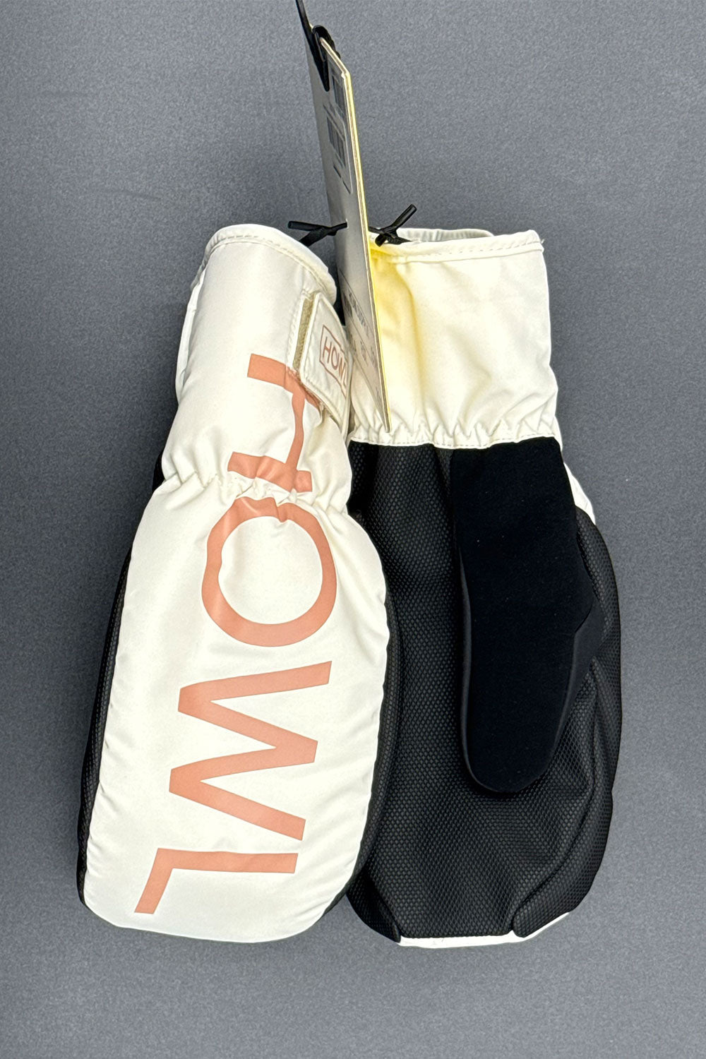 Pair of mittens with 'HOWL' branding on a gray background
