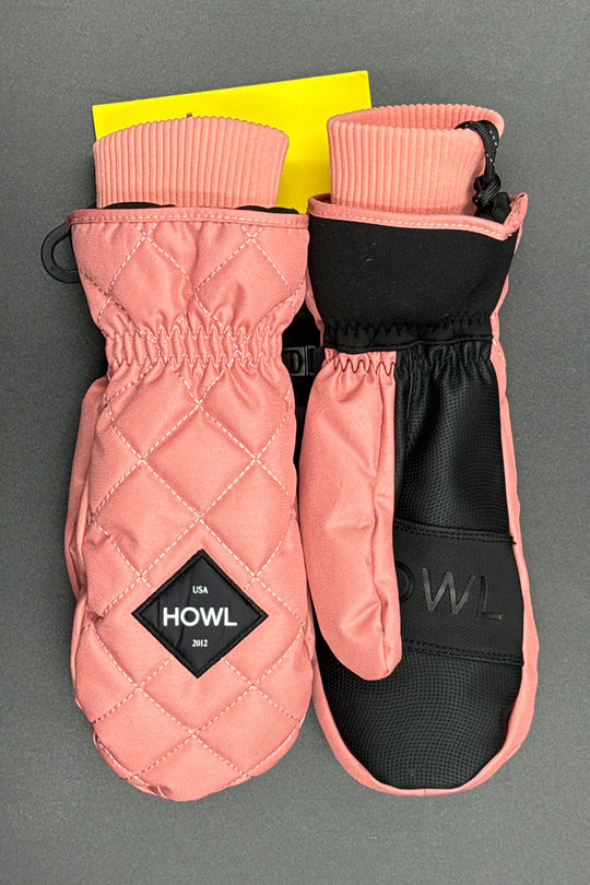 Pair of pink quilted mittens with black interior on a gray background