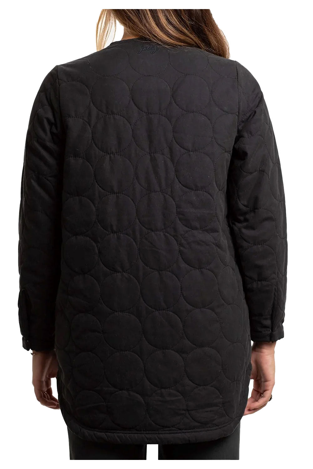 Black quilted jacket worn by a person on a white background