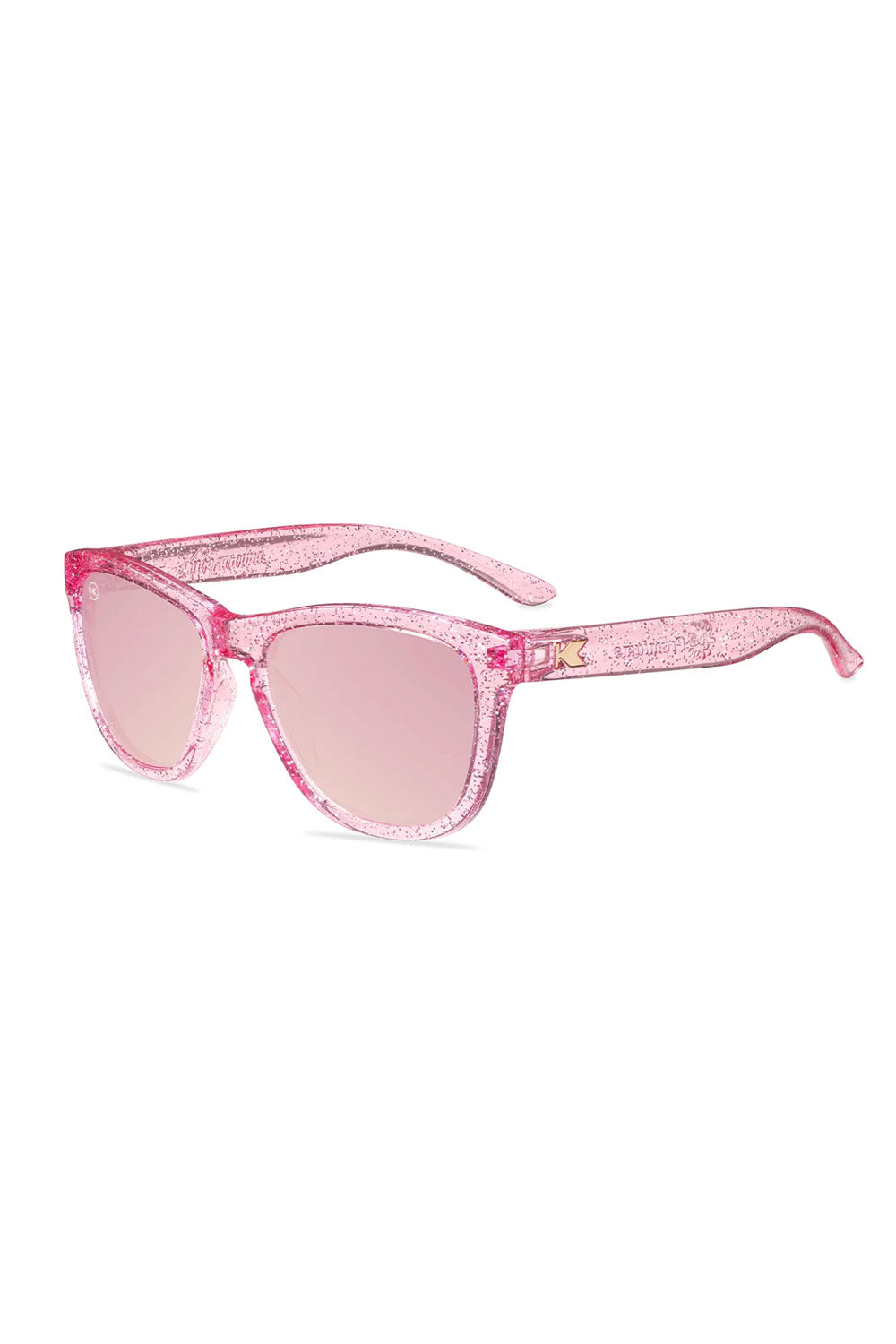 Pink sunglasses with glittery frame on a white background